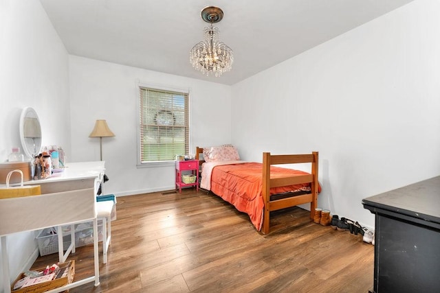 418 Mason Ln, Goodlettsville, TN 37072 - bedroom with a chandelier, wood finished floors, and baseboards