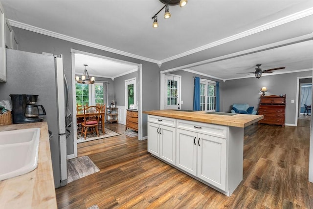 418 Mason Ln, Goodlettsville, TN 37072 - kitchen featuring butcher block countertops, white cabinetry, dark wood-style floors, freestanding refrigerator, and crown molding