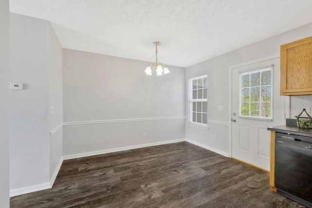 unfurnished dining area with dark wood-style flooring, baseboards, and a chandelier