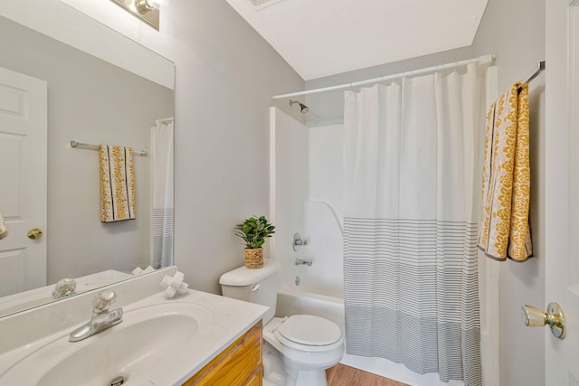 bathroom featuring toilet, shower / bath combination with curtain, and vanity