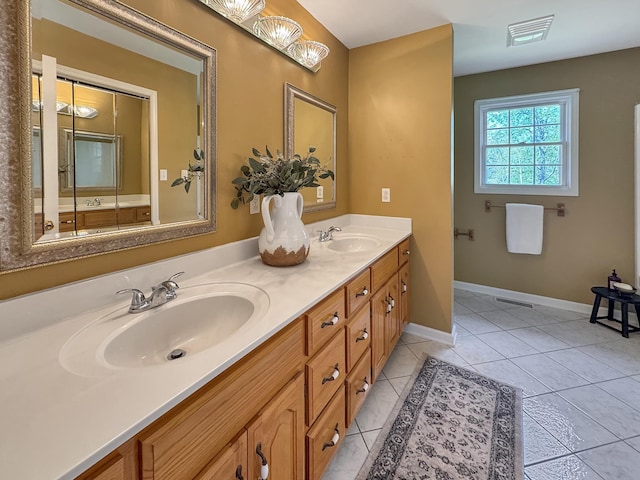 bathroom featuring a sink, double vanity, and visible vents