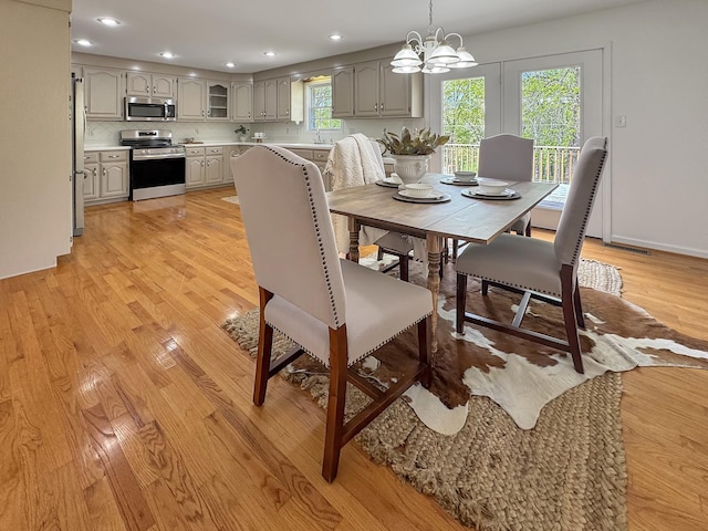 dining space with recessed lighting, a chandelier, and light wood-style floors