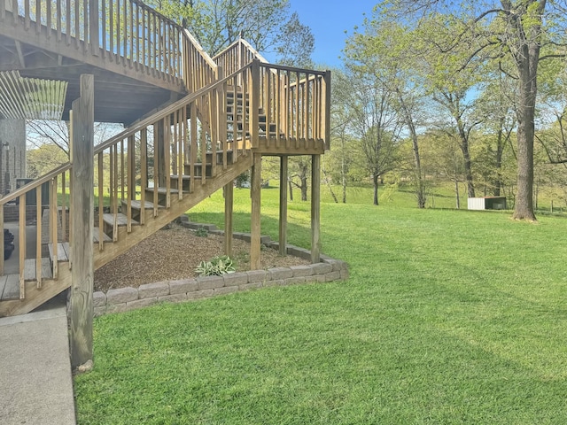 view of yard with a deck and stairs