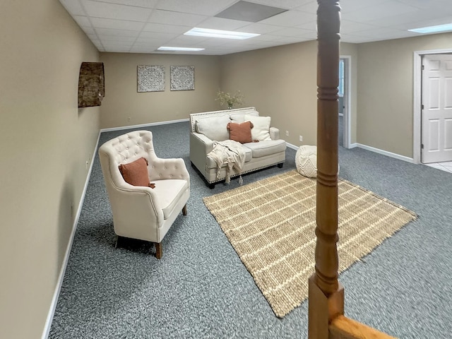 sitting room featuring carpet floors, baseboards, and a paneled ceiling