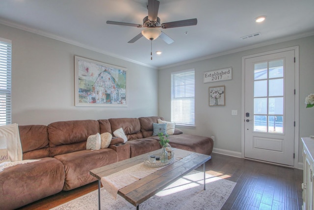 living room featuring visible vents, a ceiling fan, baseboards, and plenty of natural light