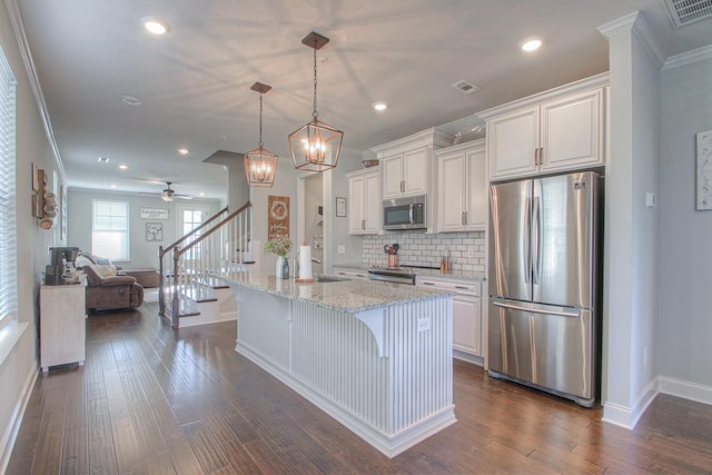 kitchen featuring visible vents, crown molding, baseboards, white cabinets, and appliances with stainless steel finishes