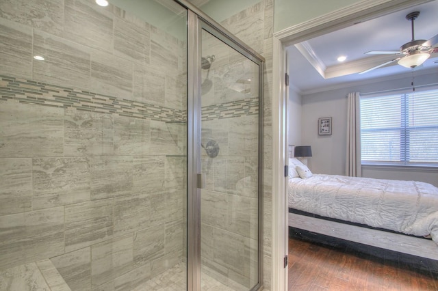 bathroom with ornamental molding, wood finished floors, connected bathroom, a shower stall, and a ceiling fan