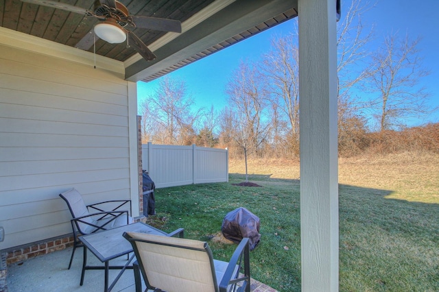 view of yard featuring fence and a ceiling fan
