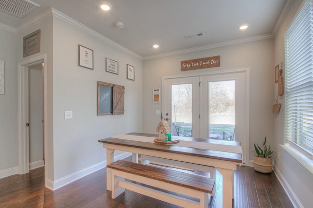dining space featuring visible vents, a healthy amount of sunlight, and dark wood-type flooring