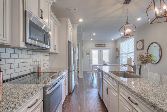 kitchen with visible vents, recessed lighting, tasteful backsplash, a sink, and appliances with stainless steel finishes