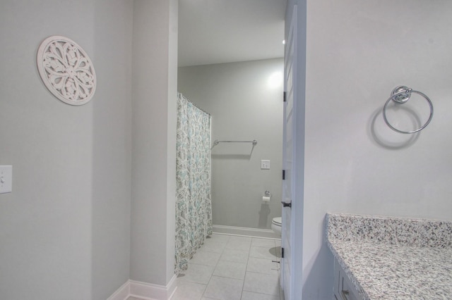 bathroom with tile patterned flooring, baseboards, a shower with shower curtain, and toilet