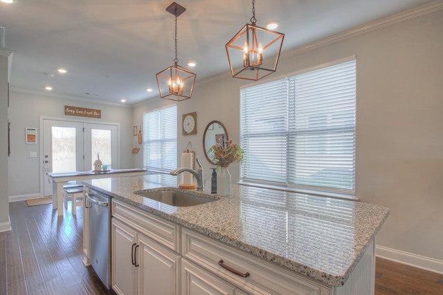 kitchen with baseboards, a chandelier, a sink, and dishwasher