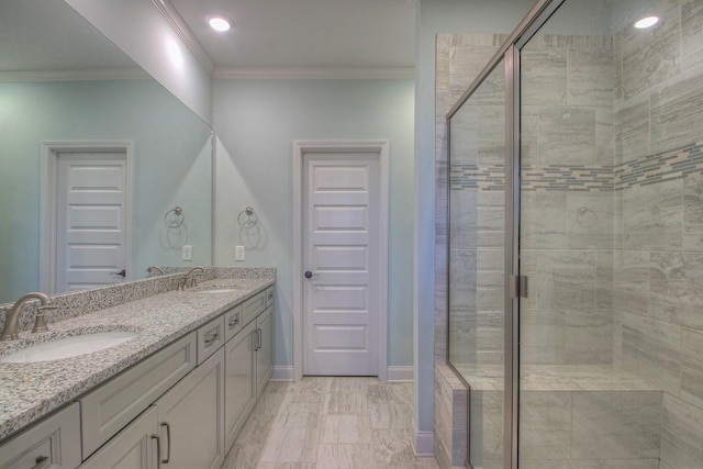 bathroom featuring double vanity, a sink, ornamental molding, and a shower stall