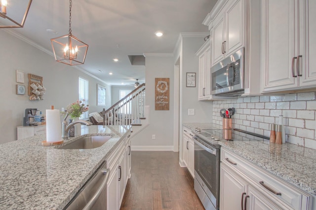 kitchen with crown molding, baseboards, dark wood-style floors, tasteful backsplash, and appliances with stainless steel finishes