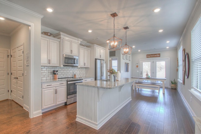 kitchen with a kitchen island with sink, recessed lighting, white cabinets, and appliances with stainless steel finishes