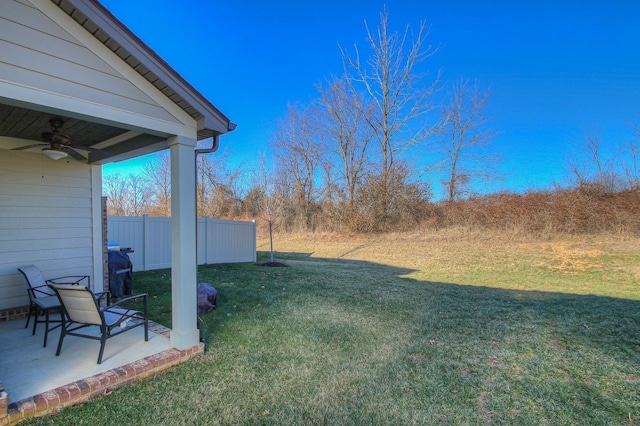 view of yard with fence, a patio, and ceiling fan