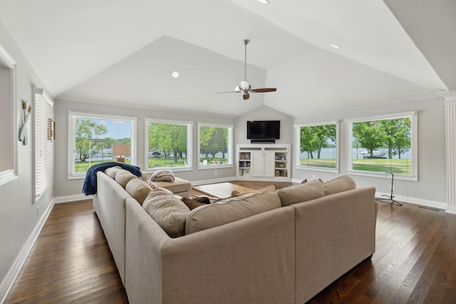 living room with ceiling fan, vaulted ceiling, baseboards, and dark wood-type flooring