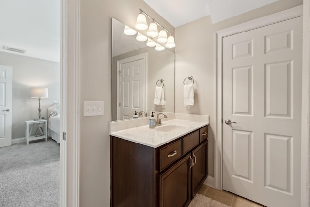 bathroom featuring baseboards, visible vents, and vanity