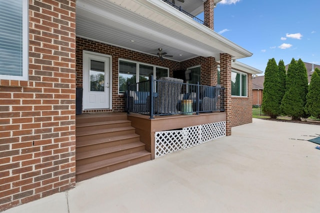 property entrance with covered porch and brick siding