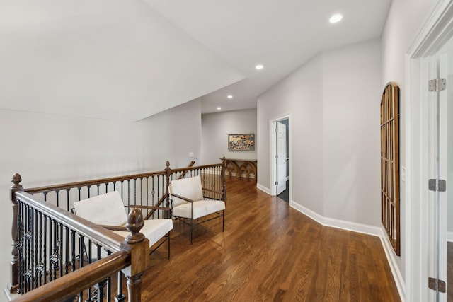 hall featuring recessed lighting, baseboards, an upstairs landing, and wood finished floors