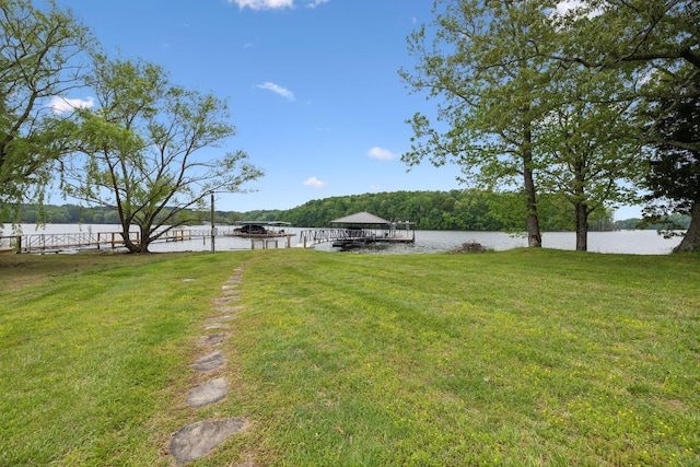 view of yard featuring a water view and a dock