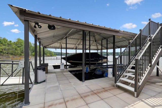 view of dock featuring boat lift, a water view, and stairway