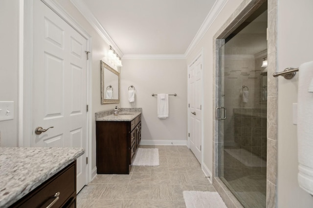 full bath with a shower stall, vanity, baseboards, tile patterned floors, and ornamental molding