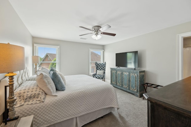 bedroom with visible vents, carpet flooring, baseboards, and a ceiling fan