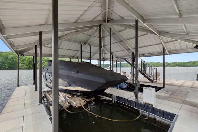 view of dock with boat lift and a water view