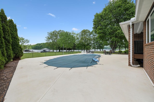 view of swimming pool with a fenced in pool, a yard, and a patio