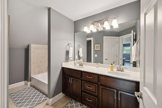 full bathroom with a sink, tile patterned floors, and double vanity