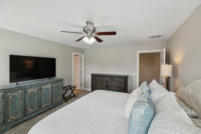 carpeted bedroom with visible vents, a ceiling fan, and baseboards