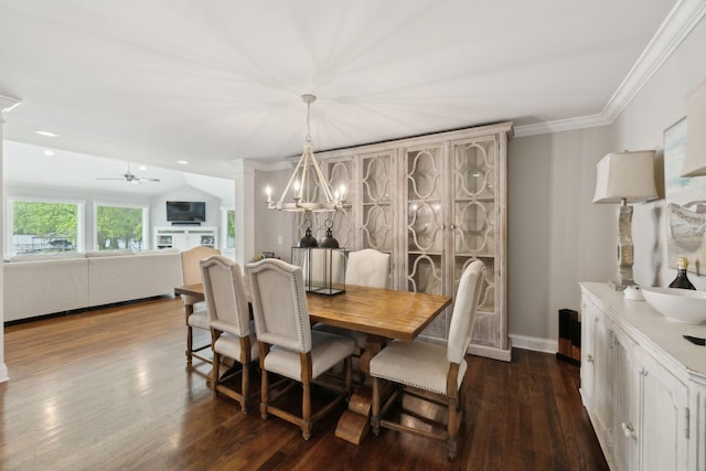 dining space featuring ornamental molding, ceiling fan with notable chandelier, and dark wood-type flooring