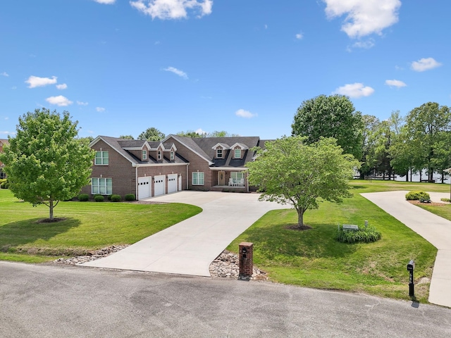 view of front of property with a garage, driveway, brick siding, and a front yard