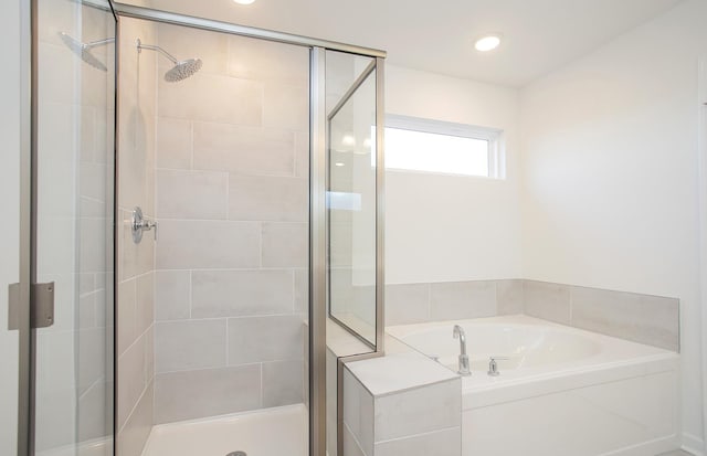 full bath featuring a shower stall and a garden tub