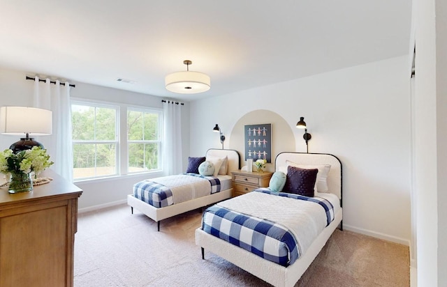 bedroom with light colored carpet, baseboards, and visible vents