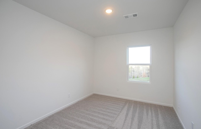 empty room with recessed lighting, baseboards, visible vents, and light carpet