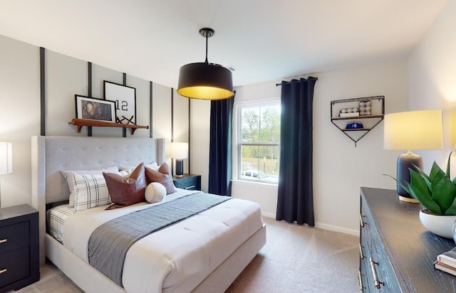 bedroom with baseboards and light carpet