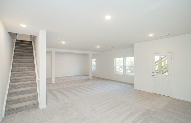 interior space with visible vents, stairs, baseboards, light colored carpet, and recessed lighting