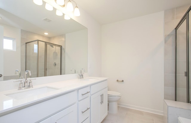 bathroom featuring double vanity, visible vents, a sink, and a stall shower