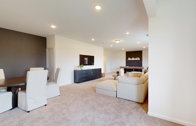 living area with recessed lighting and light carpet