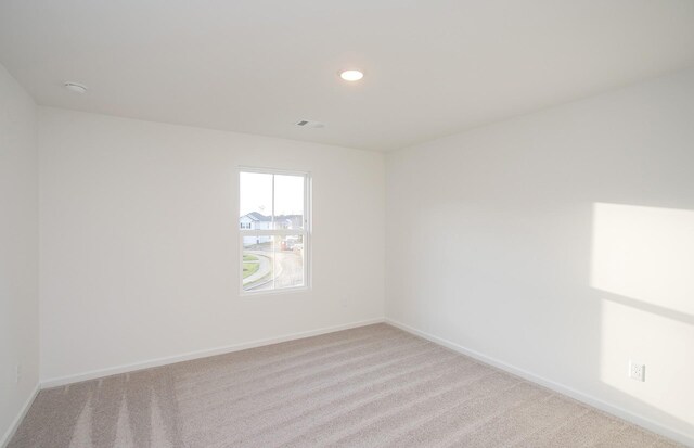 carpeted spare room with recessed lighting and baseboards