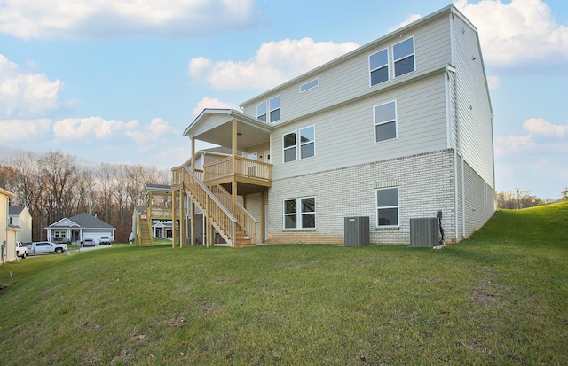 rear view of house featuring a deck, a yard, central AC, and stairway