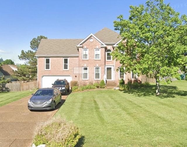 view of front facade with fence, driveway, and a front lawn