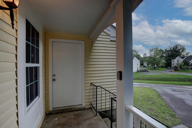 view of exterior entry featuring a yard