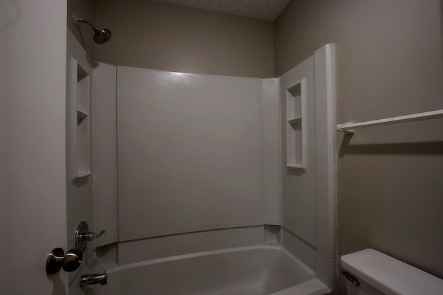 full bathroom featuring toilet, a textured ceiling, and tub / shower combination