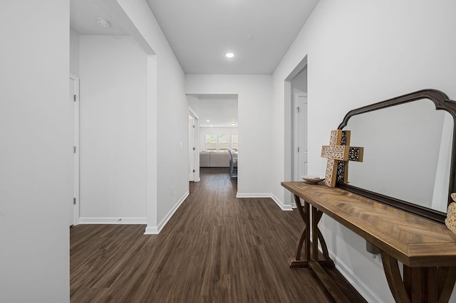 hall featuring recessed lighting, baseboards, and wood finished floors