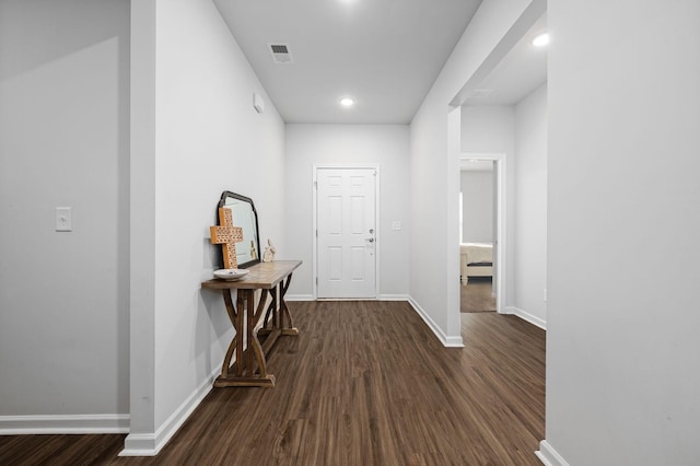 hallway with visible vents, recessed lighting, dark wood finished floors, and baseboards