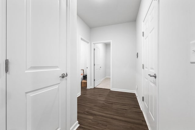 hall with baseboards and dark wood finished floors