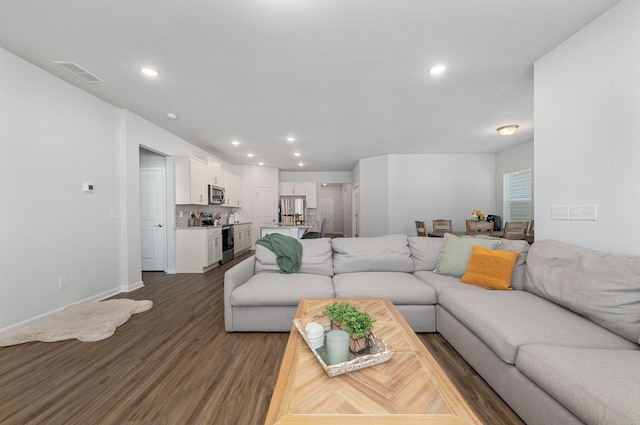 living room featuring baseboards, dark wood-type flooring, recessed lighting, and visible vents